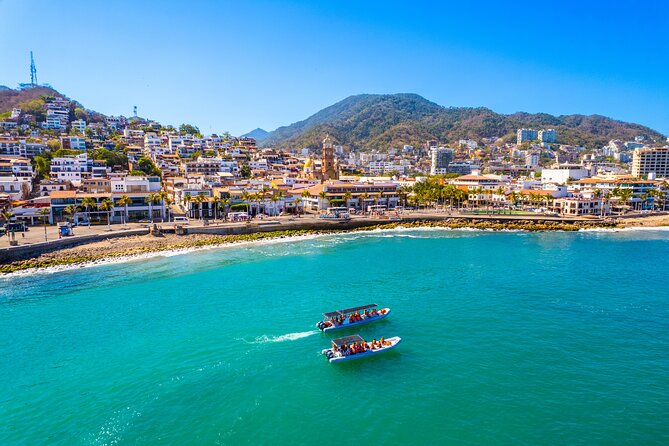 Banderas Bay from the air, with a boat crossing the turquoise shallows below Puerto Vallarta